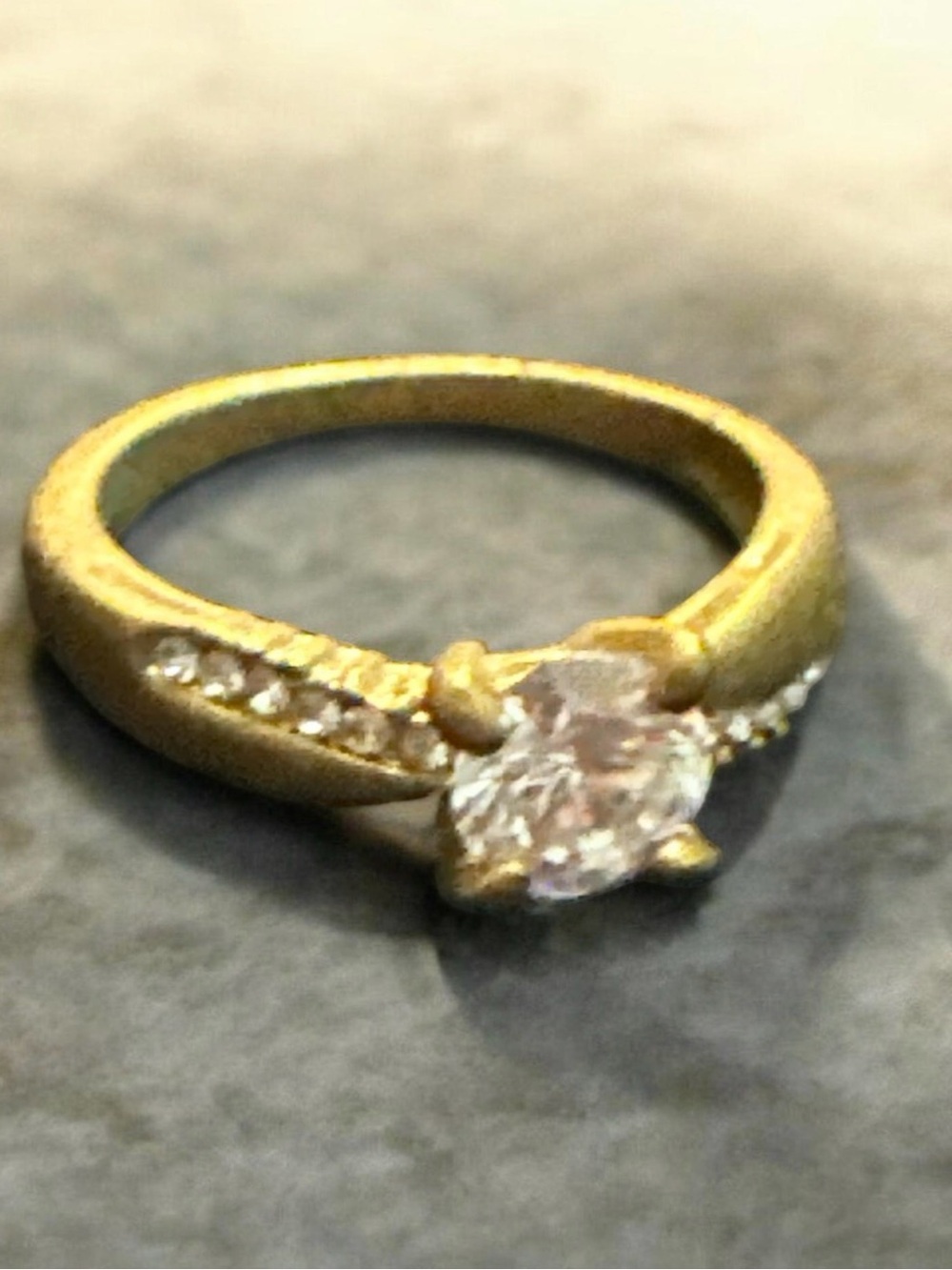 Gold Tone Crystal Solitaire Ring with Accent Stones - Gold
Size 6
1008 - Picture 2 of 2